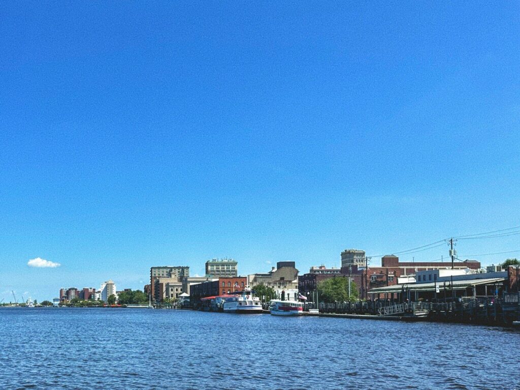 A body of water with a city in the background